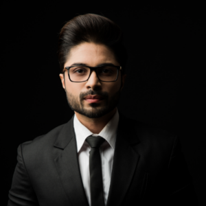 portrait young bearded indian businessman against black background moody lighting
